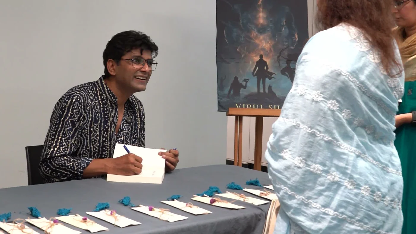 A story meets its readers at the signing table.