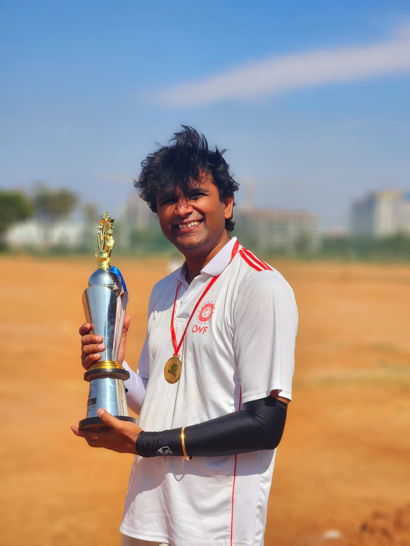 Vipul Shah holding a cricket trophy